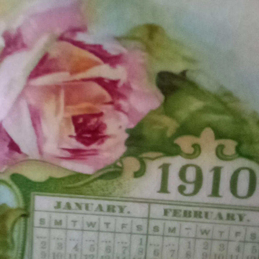 Hand painted calendar advertising plate from 1910. Turquoise & roses